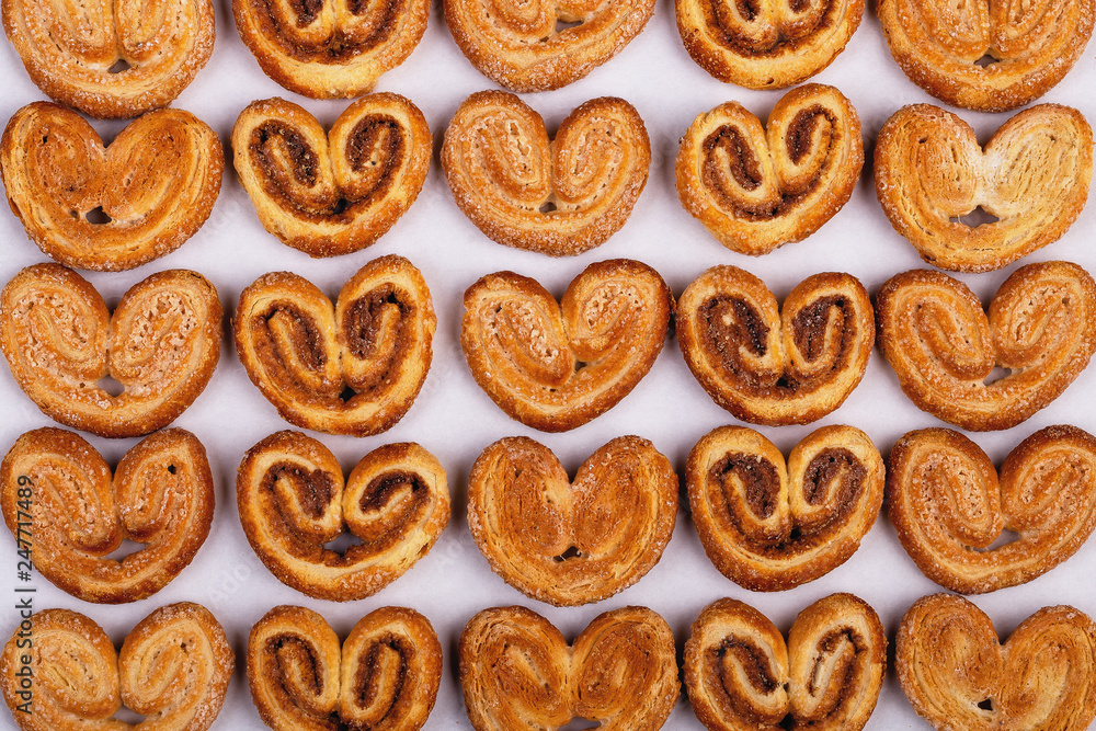 group of sugar cookies in the shape of a heart on a light background