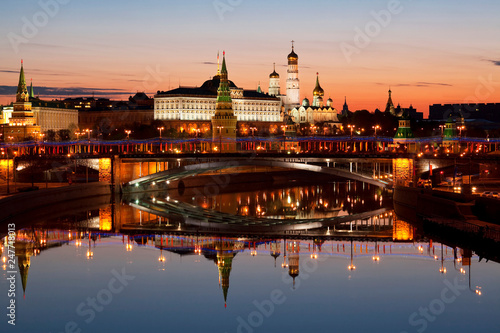 View of the Kremlin, Big stone bridge, Moscow river and their mirror image in the water at dawn, Moscow, Russia