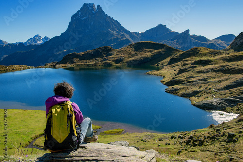 woman hiker sitting in the Pyrenees mountains near the Pic du Midi d Ossau