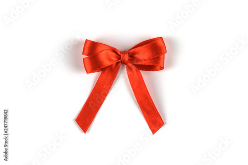 Coral silk gift bow isolated on white.
