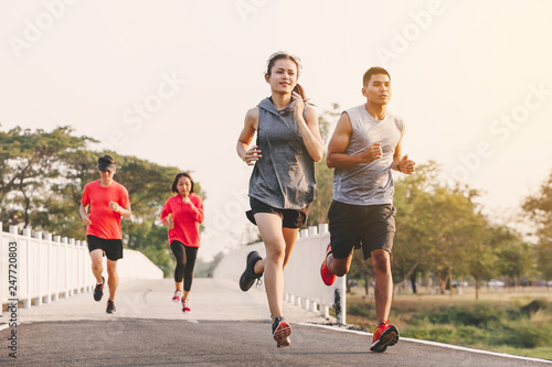 young people runner running on running road in city park