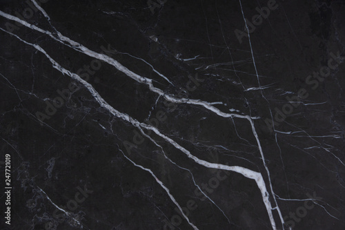 Natural stone Italian marble with white stripes on a dark background, called Nero Marquina