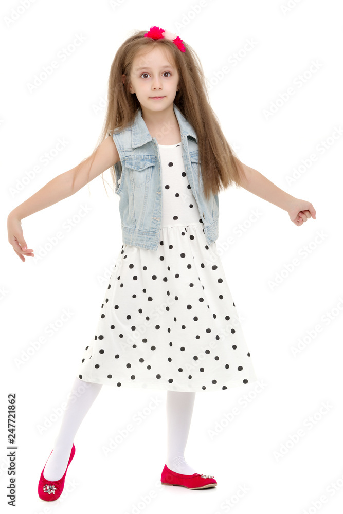 Naklejka premium A cheerful little girl is dancing.