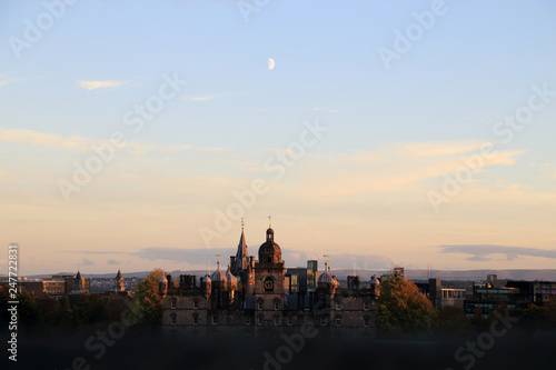 Edinburgh, Scotland. Cityscape view look from Edinburgh castle in evening seeing the moon over old buildings.
