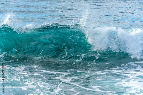 Turquoise Blue Wave Breaking and Washing into Shore in Italy © JonShore