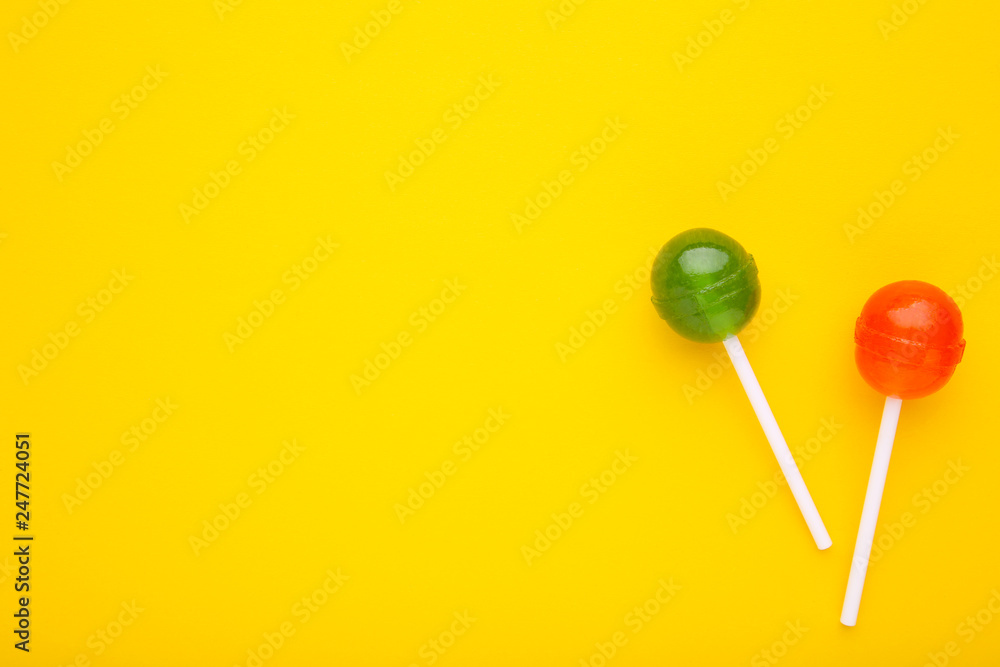 Sweet lollipops on yellow background. sweet candy concept Sweet lollipops on yellow background. sweet candy concept
