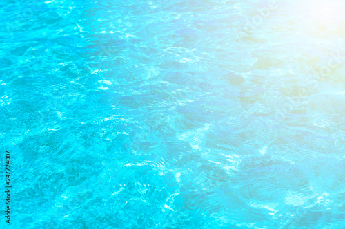Surface of blue clear swimming pool. Water background pattern for background with sunlight