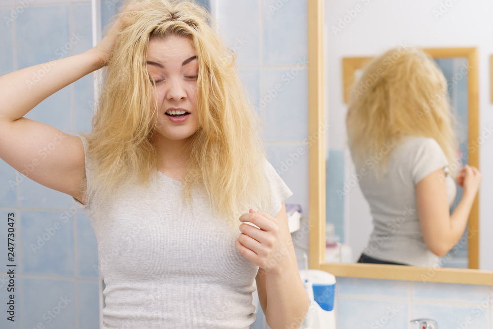 Woman feeling tired in bathroom Woman feeling tired in bathroom