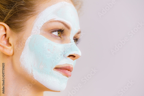 Girl with white green mud mask on face © anetlanda