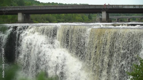 Slow motion footage of water cascading down a waterfall. photo