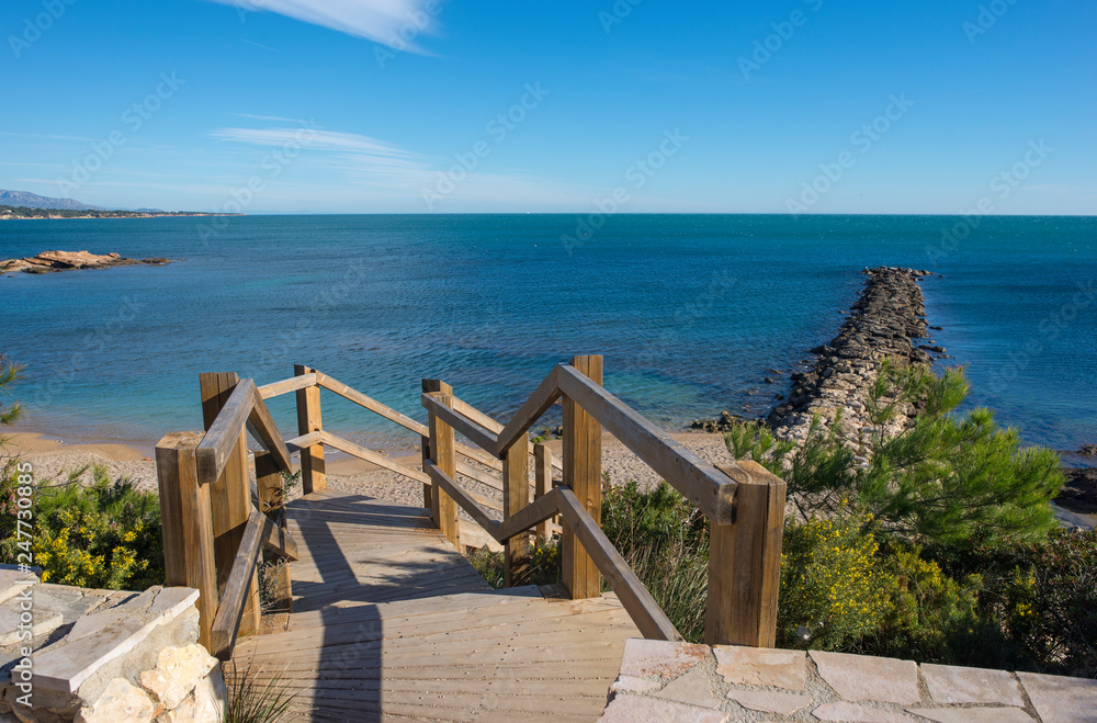 Access stairs to a sea blister beach, costa daurada