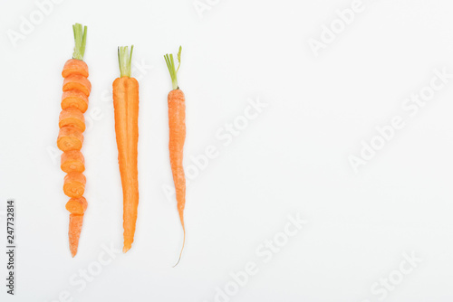 top view of sliced carrot, cut and whole carrots isolated on white with copy space