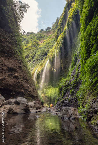 Beautiful Madakaripura waterfall flowing in rocky valley