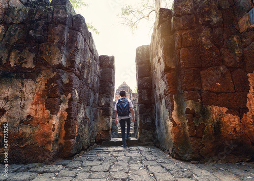 Man backpacker walking inside in Prasat Muang Sing are Ancient ruins of Khmer temple