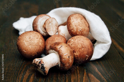 Royal champignon mushrooms in the reusable canvas bag on the wooden kitchen table. Less plastic grocery concept