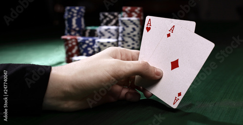 closeup. casino chips and playing cards in the player's hand.