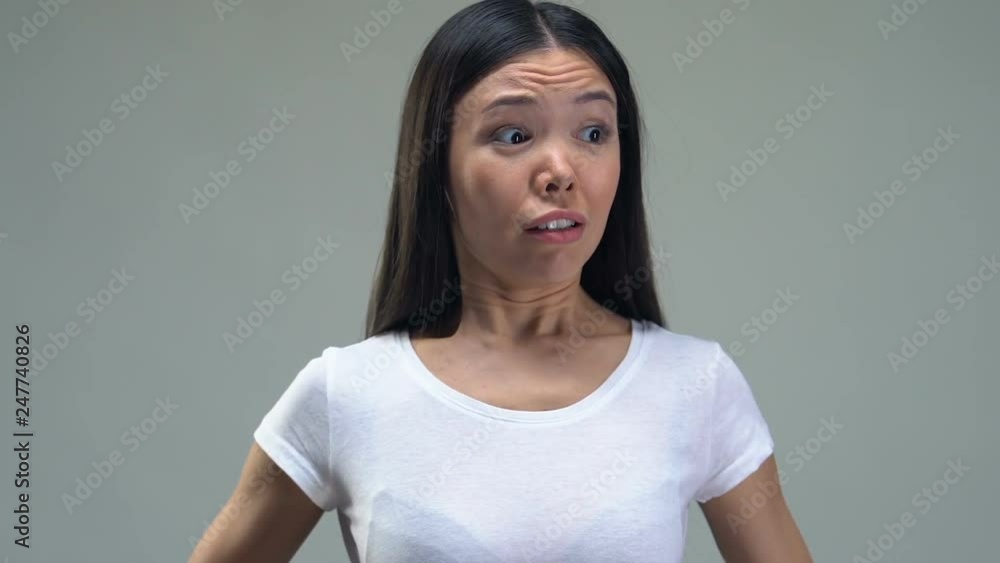 Asian lady putting tape-line tightly on waist, desire to be skinny, healthy diet Asian lady putting tape-line tightly on waist, desire to be skinny, healthy diet