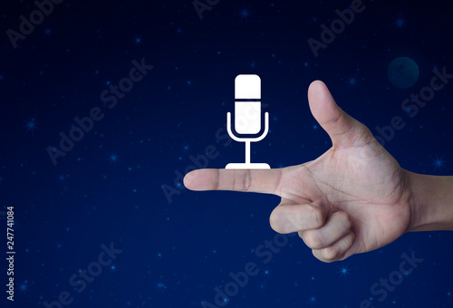 Microphone flat icon on finger over fantasy night sky and moon, Business communication concept