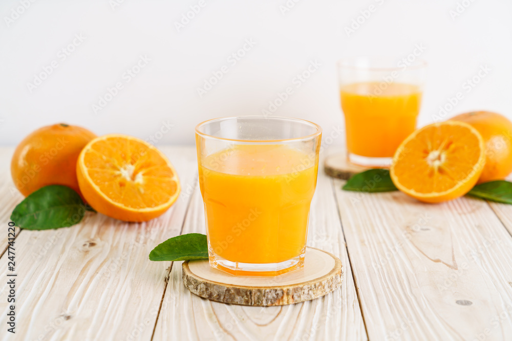 Fresh orange juice on wood background Fresh orange juice on wood background