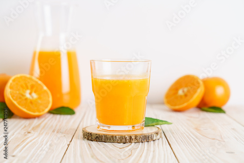 Fresh orange juice on wood background