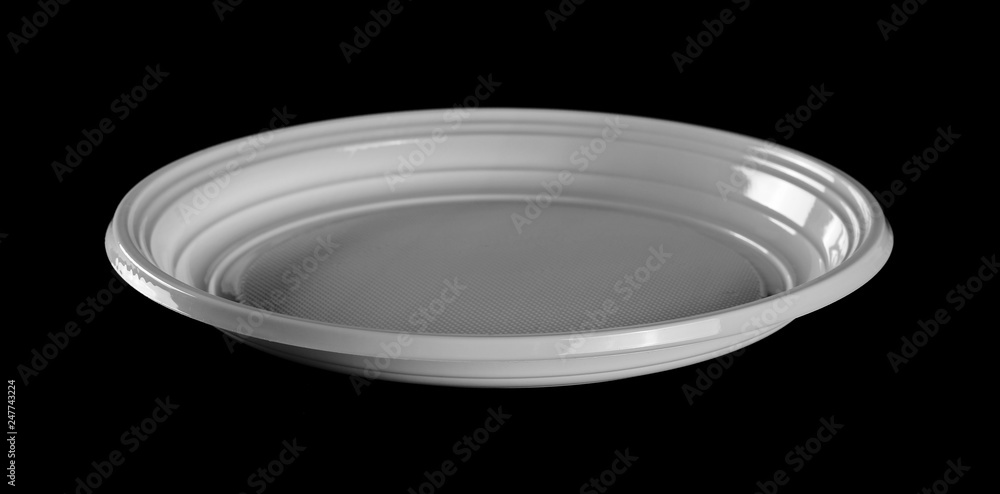 Disposable white plastic plate with spoon and fork clipping path, isolated on black background Disposable white plastic plate with spoon and fork clipping path, isolated on black background