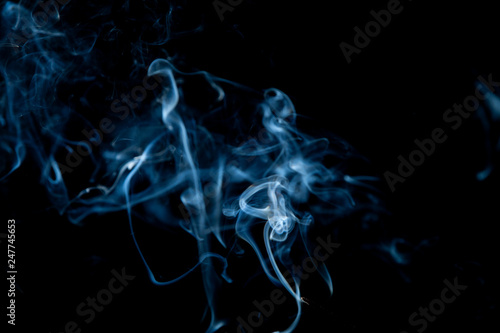 White smoke swirls on black background
