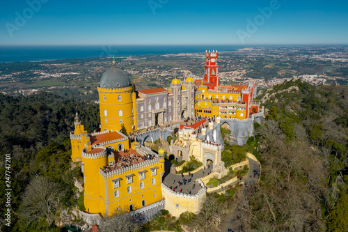 Aerial view of Pena Palace, castle stands on Sintra Mountains; monument and one of the Seven Wonders of Portugal, mixture of eclectic styles includes the Neo-Gothic, Manueline, Islamic, Renaissance