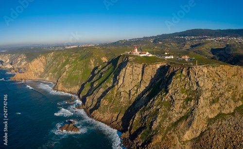 Aerial; drone view of westernmost point of mainland Europe, Cabo da Roca; touristic attaction of the country; edge of the Earth with steep stony slopes and turquoise water; dangerous cliff Peninsula