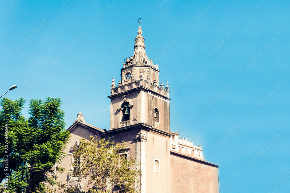 Facade of old cathedral on historical street of Catania, Sicily, Italy.