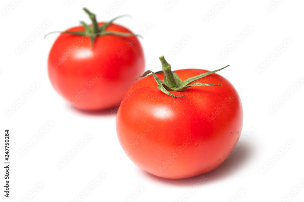 closeup of two fresh tomatoes on white background closeup of two fresh tomatoes on white background