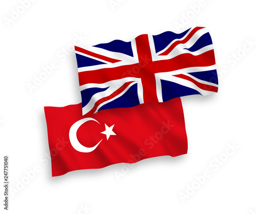 National vector fabric wave flags of Turkey and Great Britain isolated on white background. 1 to 2 proportion.