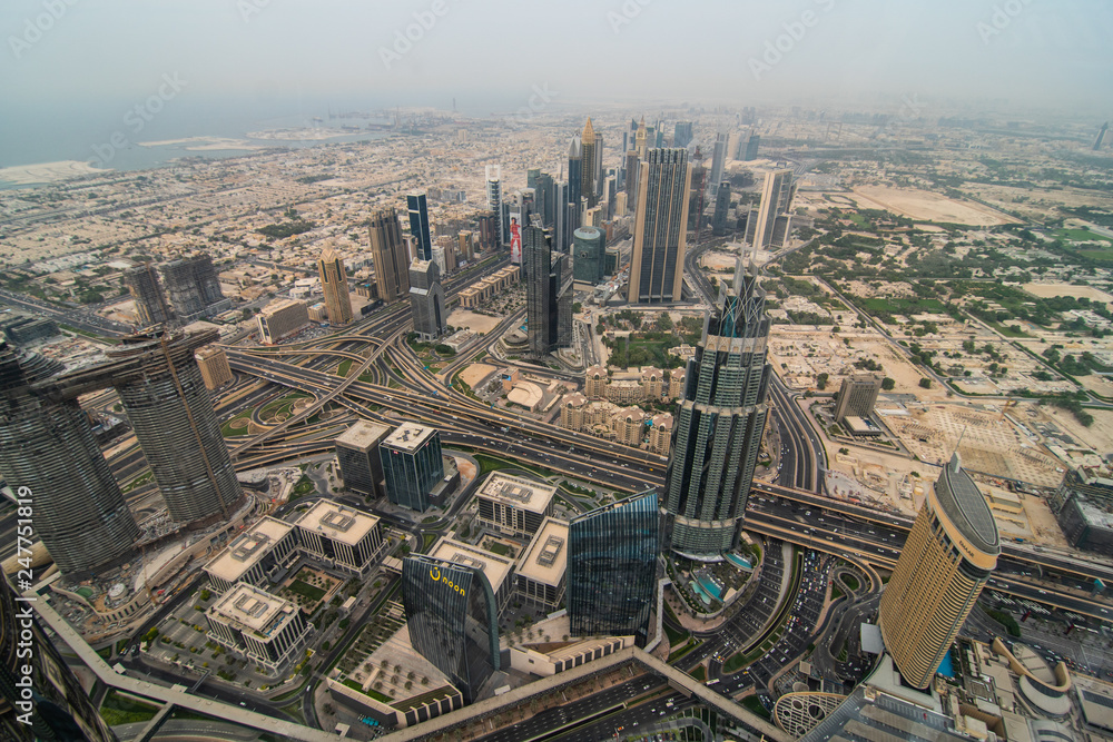 Fototapeta premium DUBAI, UAE - October, 2018: Top view of Dubai urban skyline from Burj Khalifa. Dubai city view from the top of Burj Khalifa