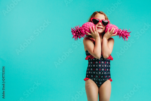 Fotografie, Obraz Cute girl in swimsuit with two pineapples