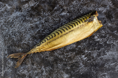 Smoked mackerel without head on black background. copyspace top view photo