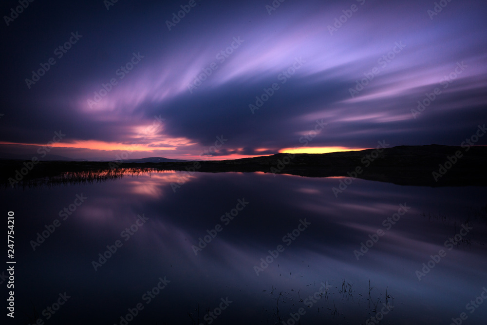 Long exposure on night sky and small lake in area of Nordgruvefeltet in middle Norway.