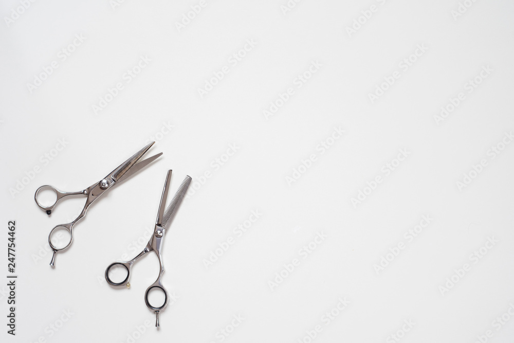 flat lay open pair of hairdressing scissors isolated on white background in the down left corner flat lay open pair of hairdressing scissors isolated on white background in the down left corner
