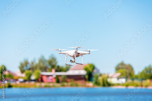Drone copter with digital camera, blur river on background