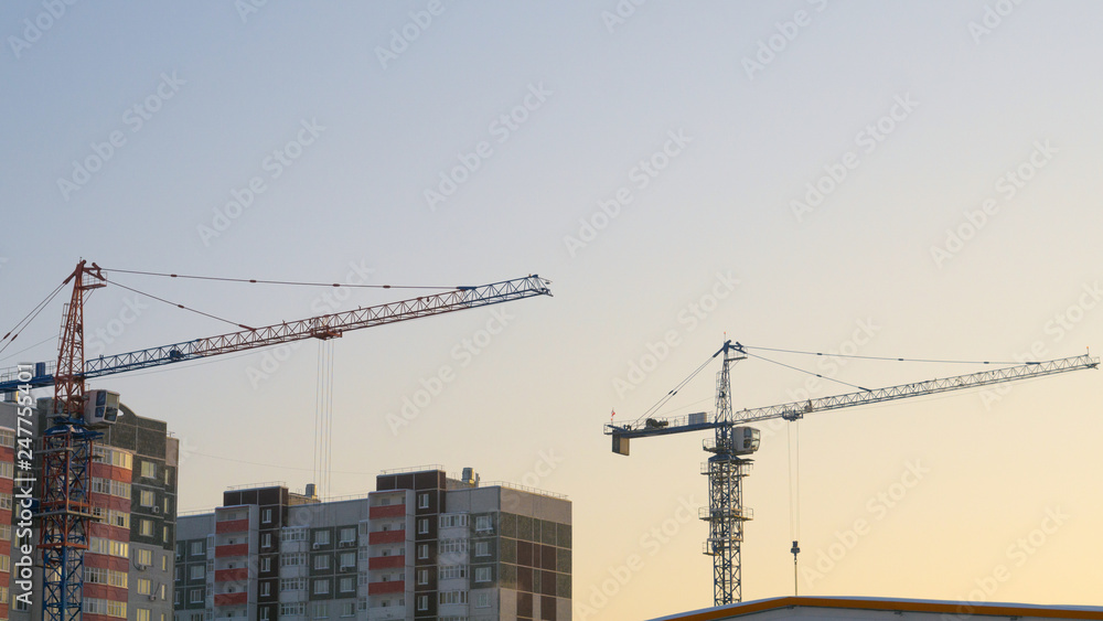 two cranes building a house two cranes building a house