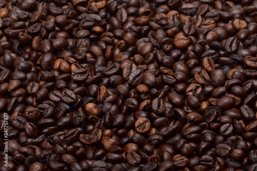 Texture of fresh roasted fragrant coffee beans. Ingredient for an invigorating morning drink