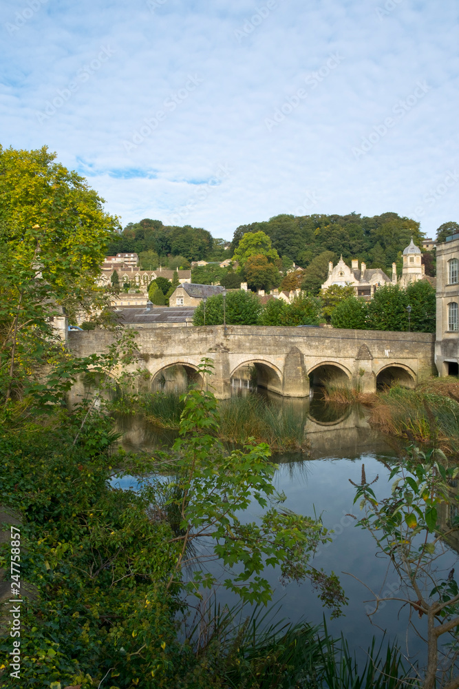 The well known ancient bridge over the River Avon with its one-time chapel and later lock-up in autumn sunshine, Bradford on Avon, Wiltshire, UK