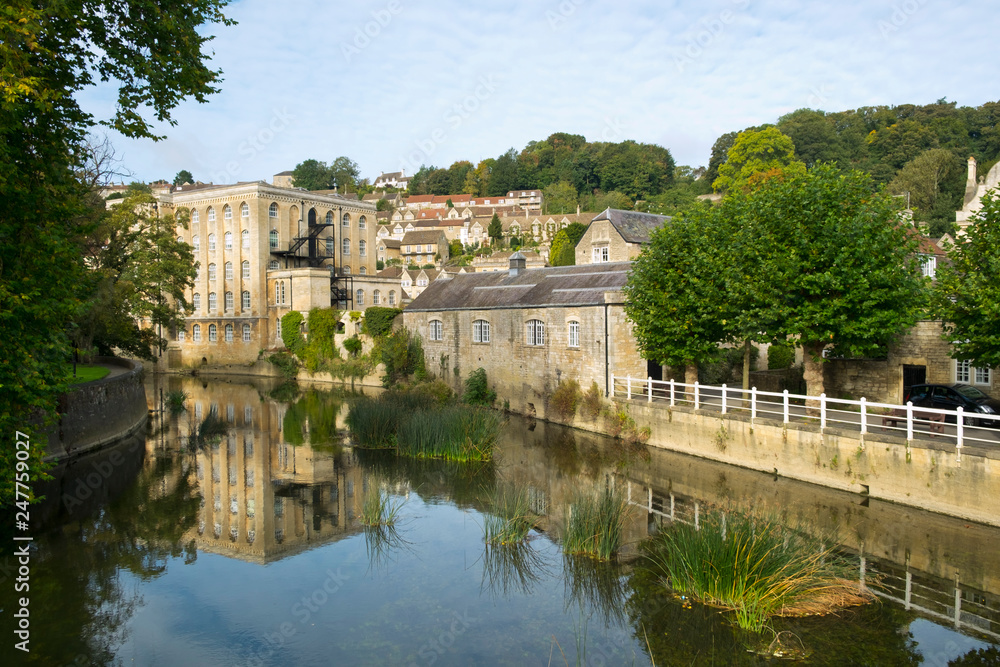 Picturesque homes climb the hill above the River Avon in autumn sunshine, Bradford on Avon, Wiltshire, UK