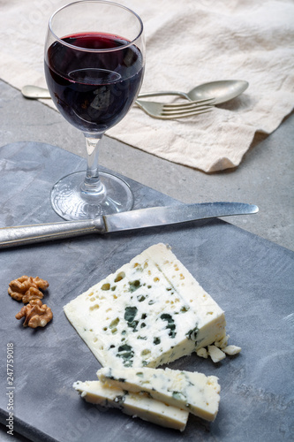 French blue cheese Roquefort, made from sheep milk in caves of Roquefort-sur-Soulzon and glas with red wine