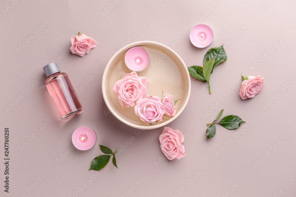 Spa composition with candles, flowers and essential oil on light background Spa composition with candles, flowers and essential oil on light background