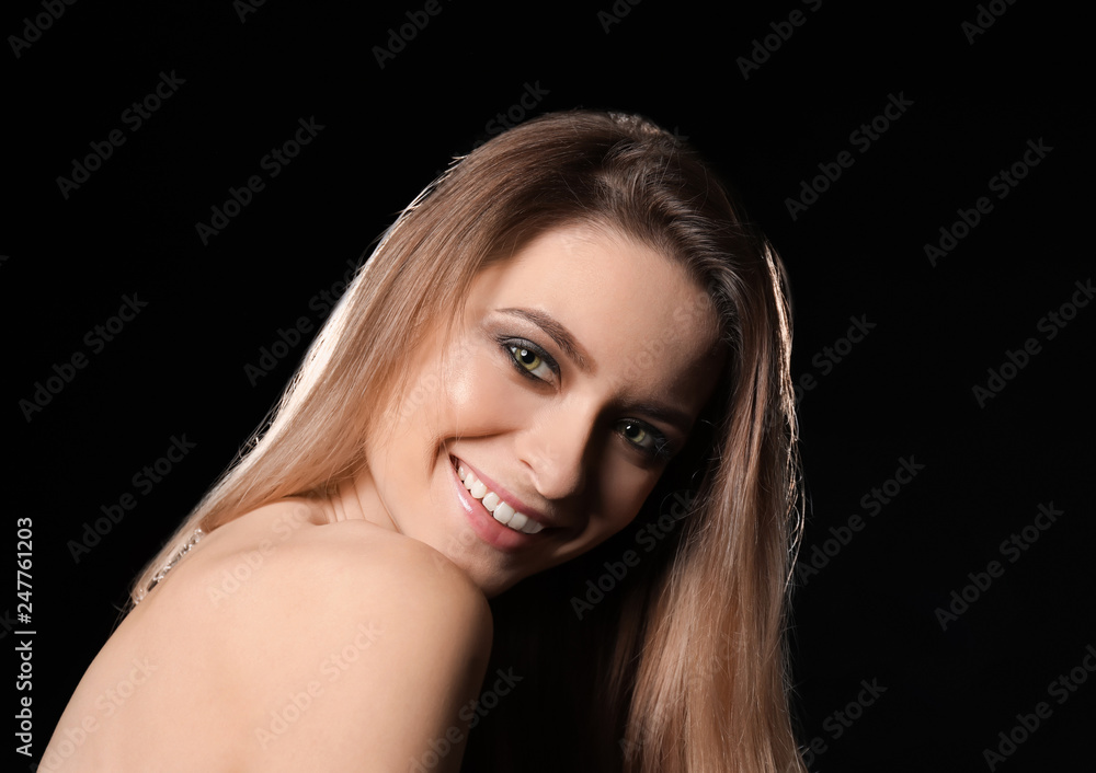 Fototapeta premium Portrait of beautiful young woman on dark background
