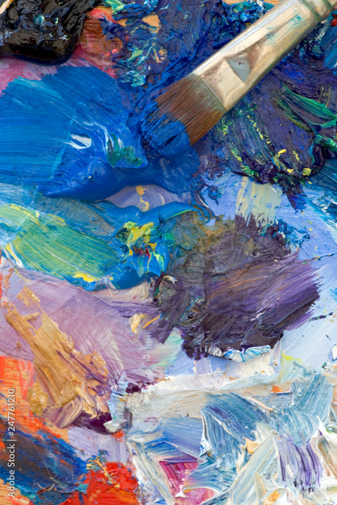 Fototapeta premium Artists oil paints and brush multi coloured close up semi abstract