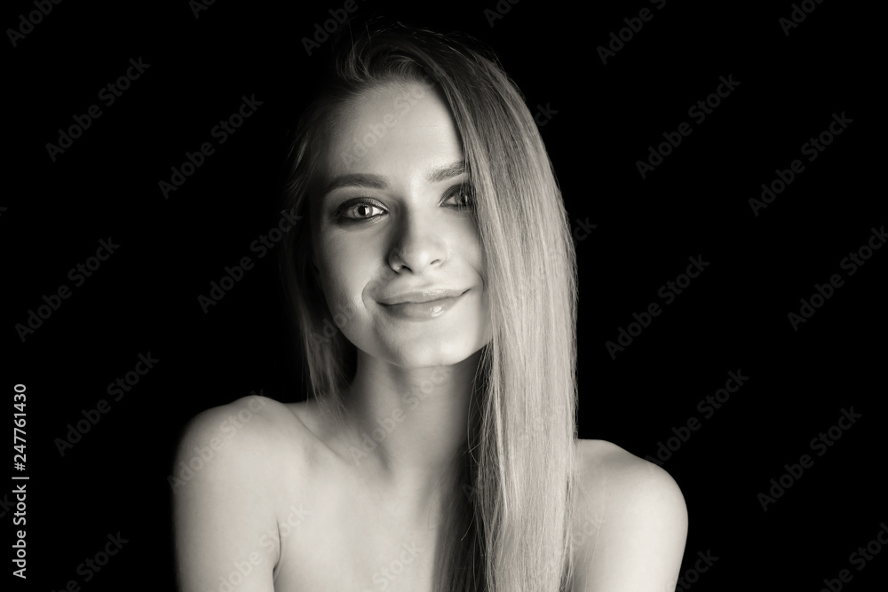 Black and white portrait of beautiful young woman on dark background Black and white portrait of beautiful young woman on dark background