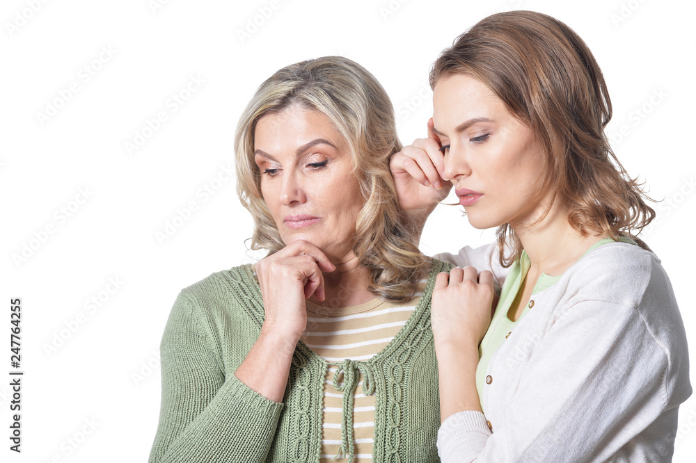 sad senior woman with daughter on white background