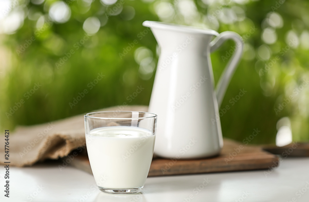 Glass of fresh milk on table outdoors Glass of fresh milk on table outdoors