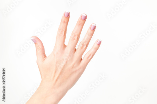 Closeup view of female hand. Woman shows 5 fingers  open palm  stop gesture. Horizontal color photography.