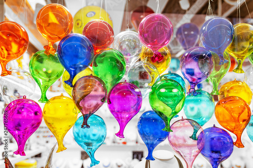Colorful decorated objects made of a famous murano glass in a shop window in Venice